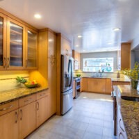 Light Brown Kitchen Cabinets and Black Tone Granite Countertop