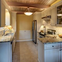 White Kitchen Cabinets with Black Handles and Granite Countertops