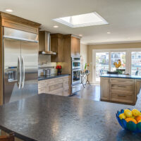 Brown Kitchen Cabinets and Black Penninsula