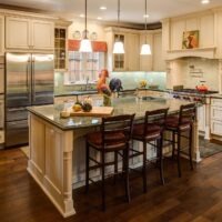 Cream Kitchen with Green Tone Granite Countertops