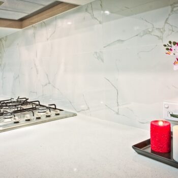 White Ceramic Backsplash with a Flower